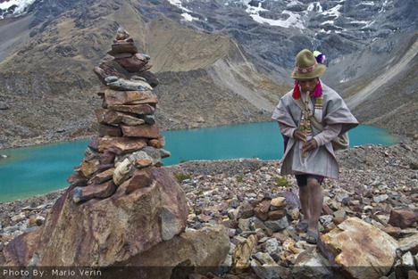 Shaman and apacheta at Humantay Lake.
